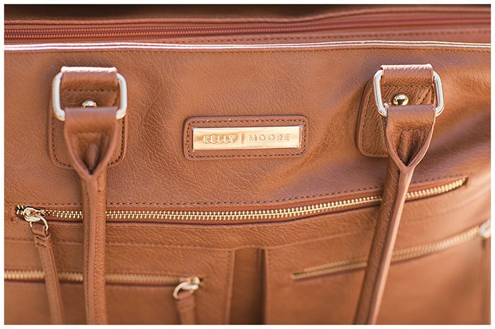 The logo of Kelly Moore Libby 2 Camera Bag.