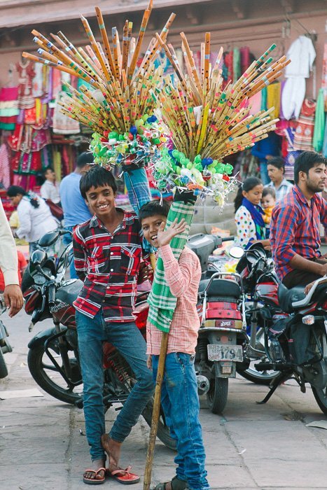 Travel photography of two boys smiling at the camera in India.