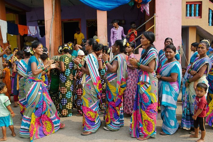 Travel photography of a group of colourfully dressed women on the streets in India.