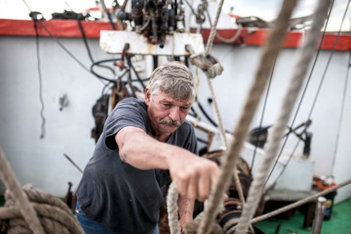 portrait of a sailor readying a boat