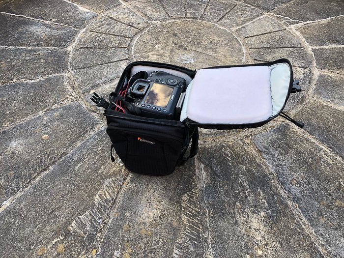 a toploader DSLR camera bag on stone ground